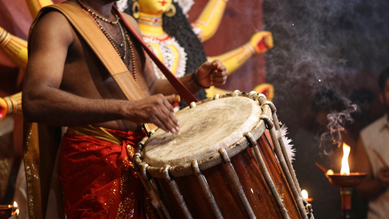A traditional Dhaki drummer playing a feathered drum in front of a beautifully crafted Goddess Durga idol.